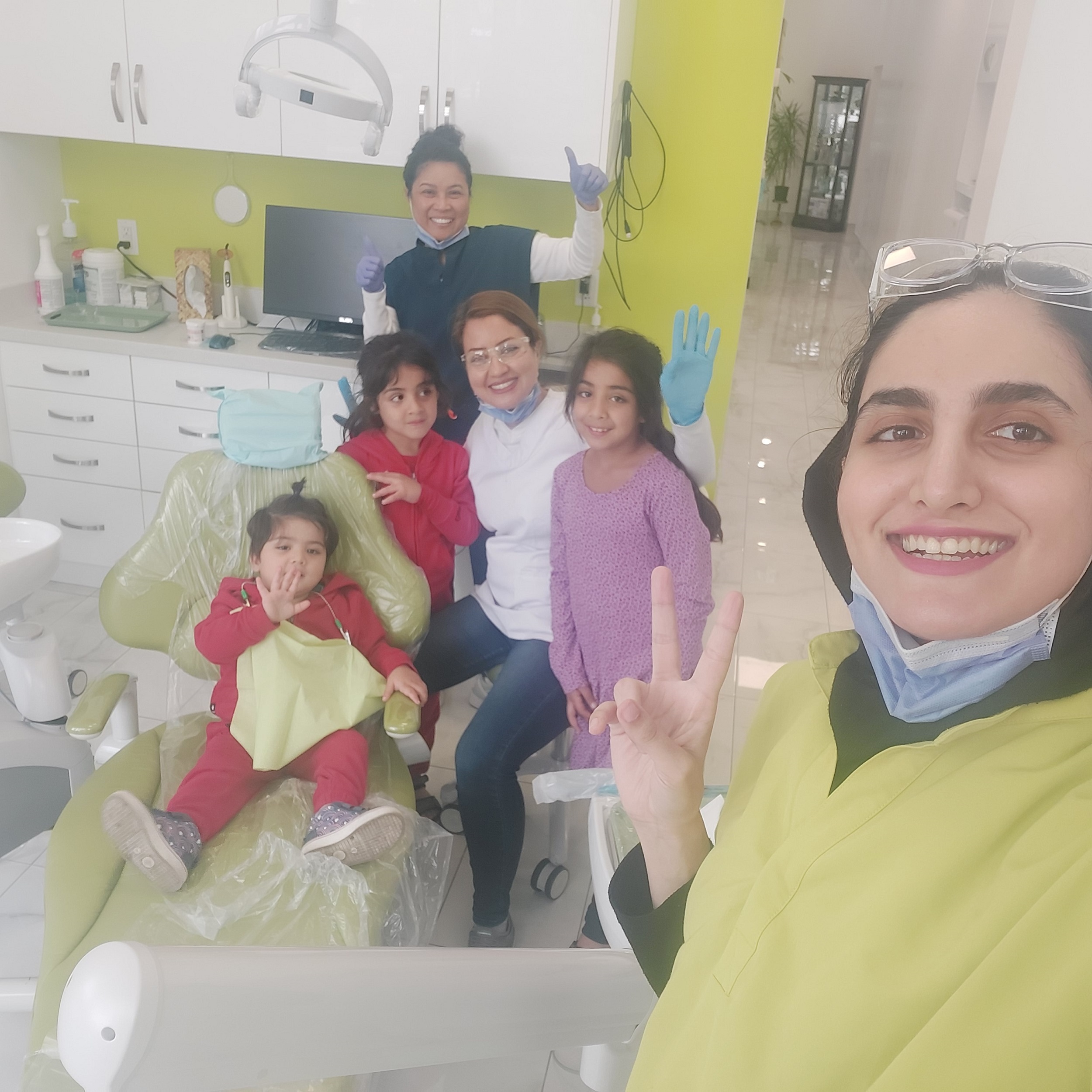 Dr. Shiva and young patients at Brilliant Dentistry