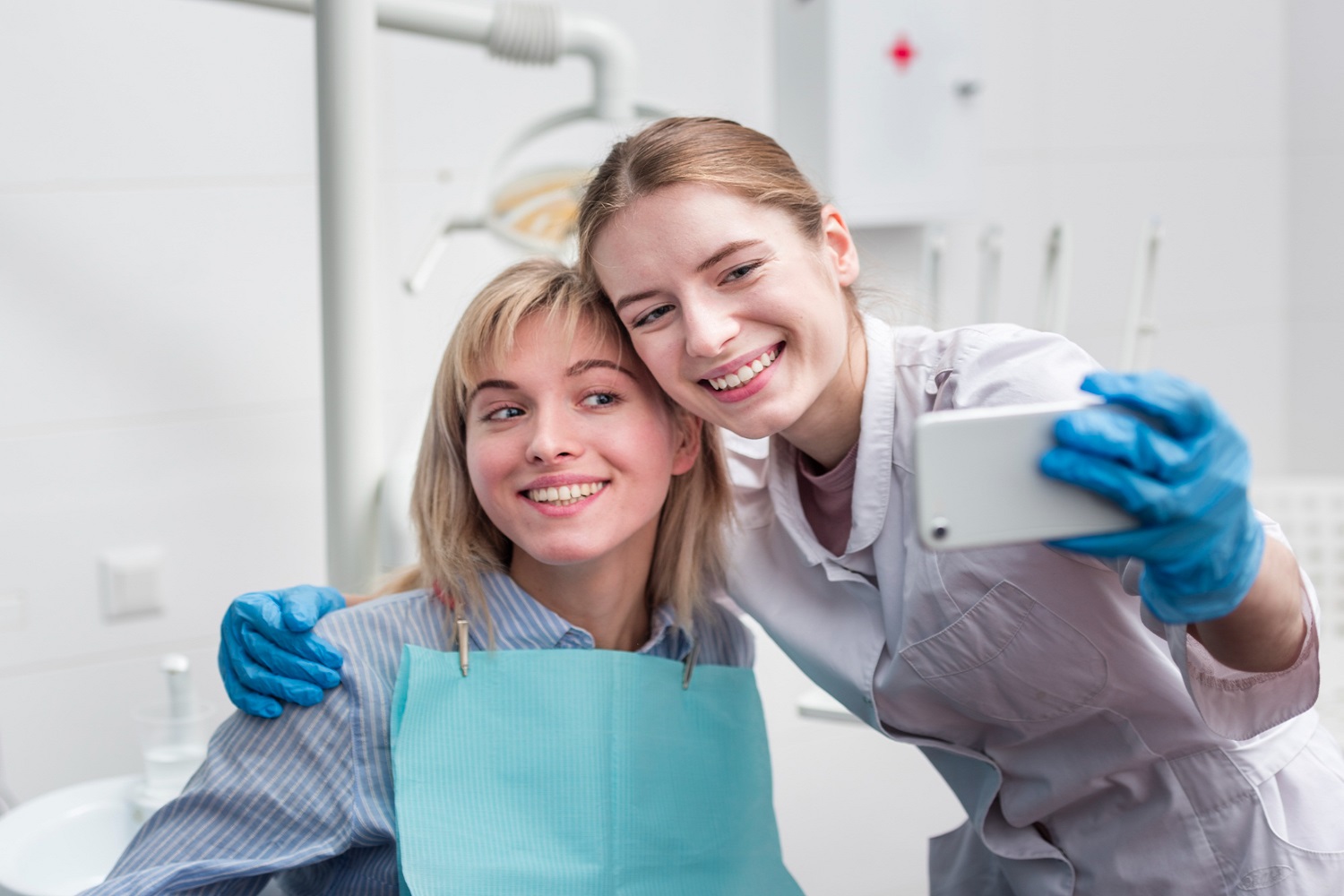 Patient and dental team smiling after a visit