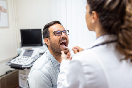 Dental professional completing an oral screening